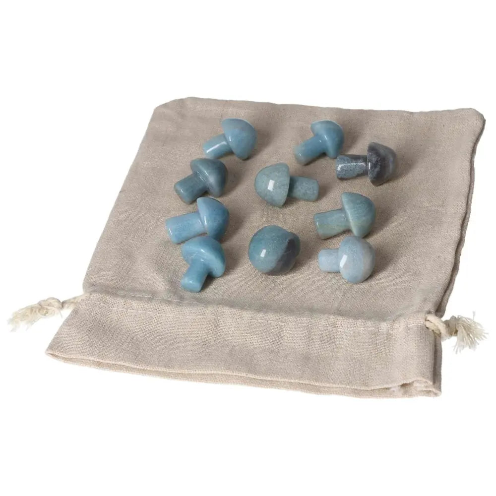 Small blue Trolleite mushroom stones on a beige cloth, symbolizing intuition and spiritual awareness for Third Eye and Crown Chakra healing.