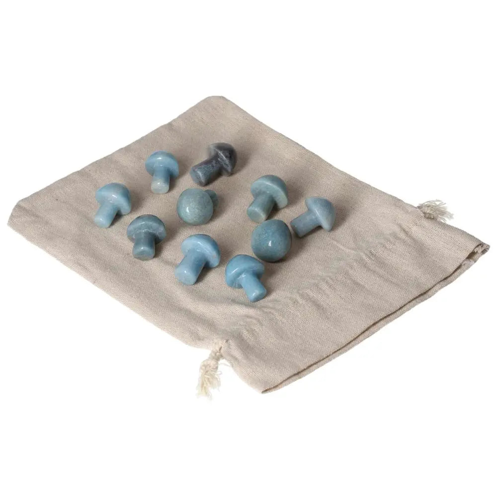 Collection of Trolleite small mushroom stones on cloth, symbolizing spiritual awareness and intuition with rich blue to violet hues.