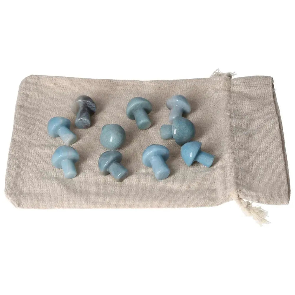 Trolleite small mushroom stones on a cloth pouch, emanating rich blue hues for spiritual awareness and intuitive potential.