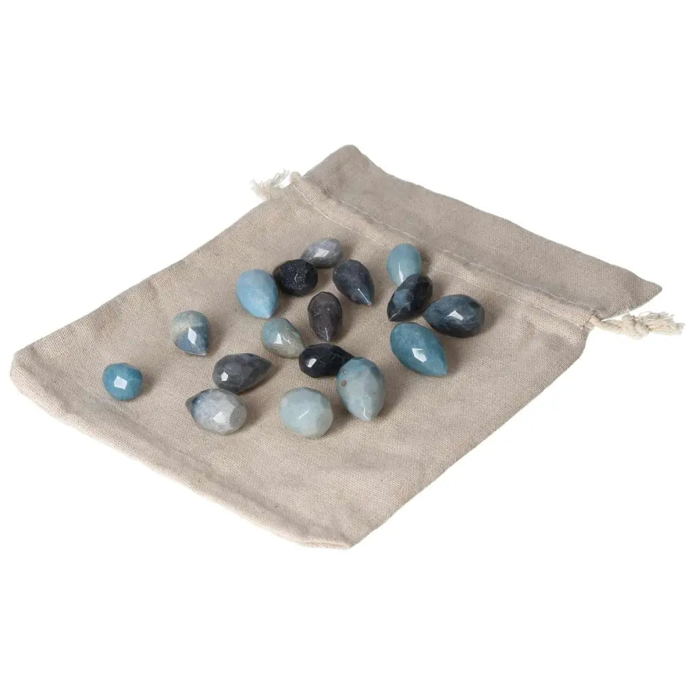 Collection of trolleite stones in a drawstring pouch, showcasing varying shades of blue and violet, symbolizing intuition and spiritual awareness.