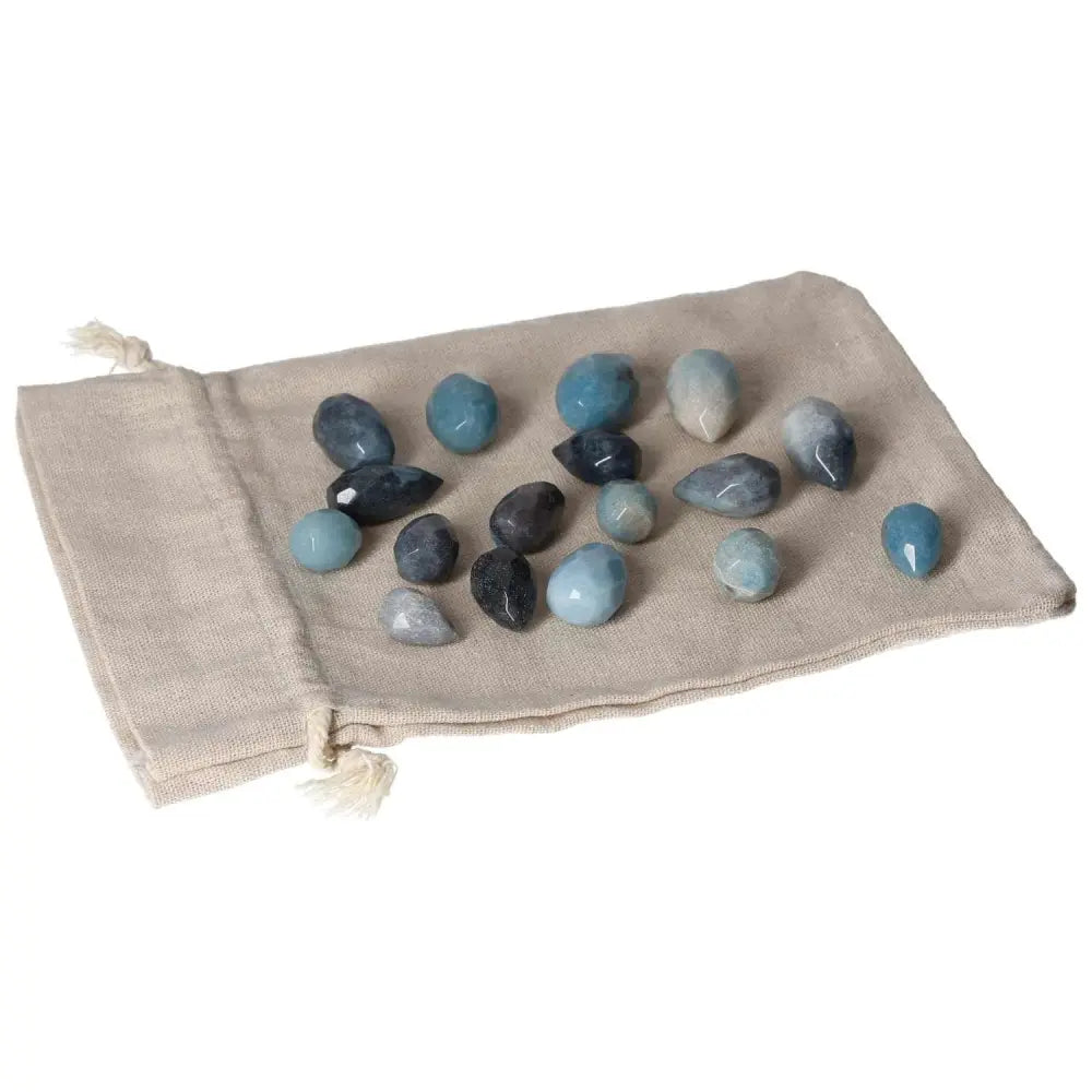 Trolleite Small Tear stones on a cloth bag, showcasing rich blue to violet hues, ideal for enhancing spiritual awareness and intuition.