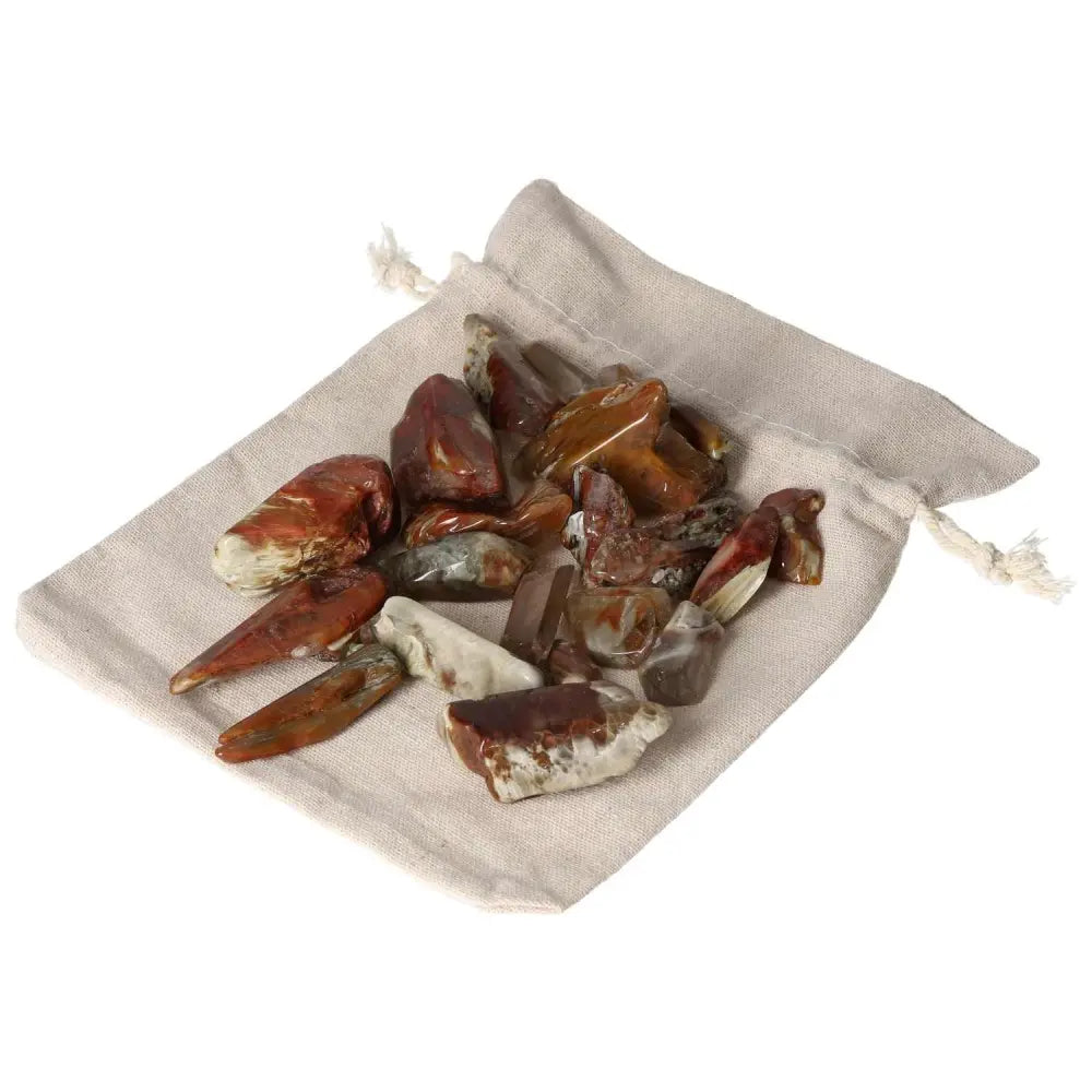 Alt Tag: Tumbled Amphibole gemstones in a drawstring bag, part of the Sylvia Crystals collection, showcasing spiritual elegance and luxury.