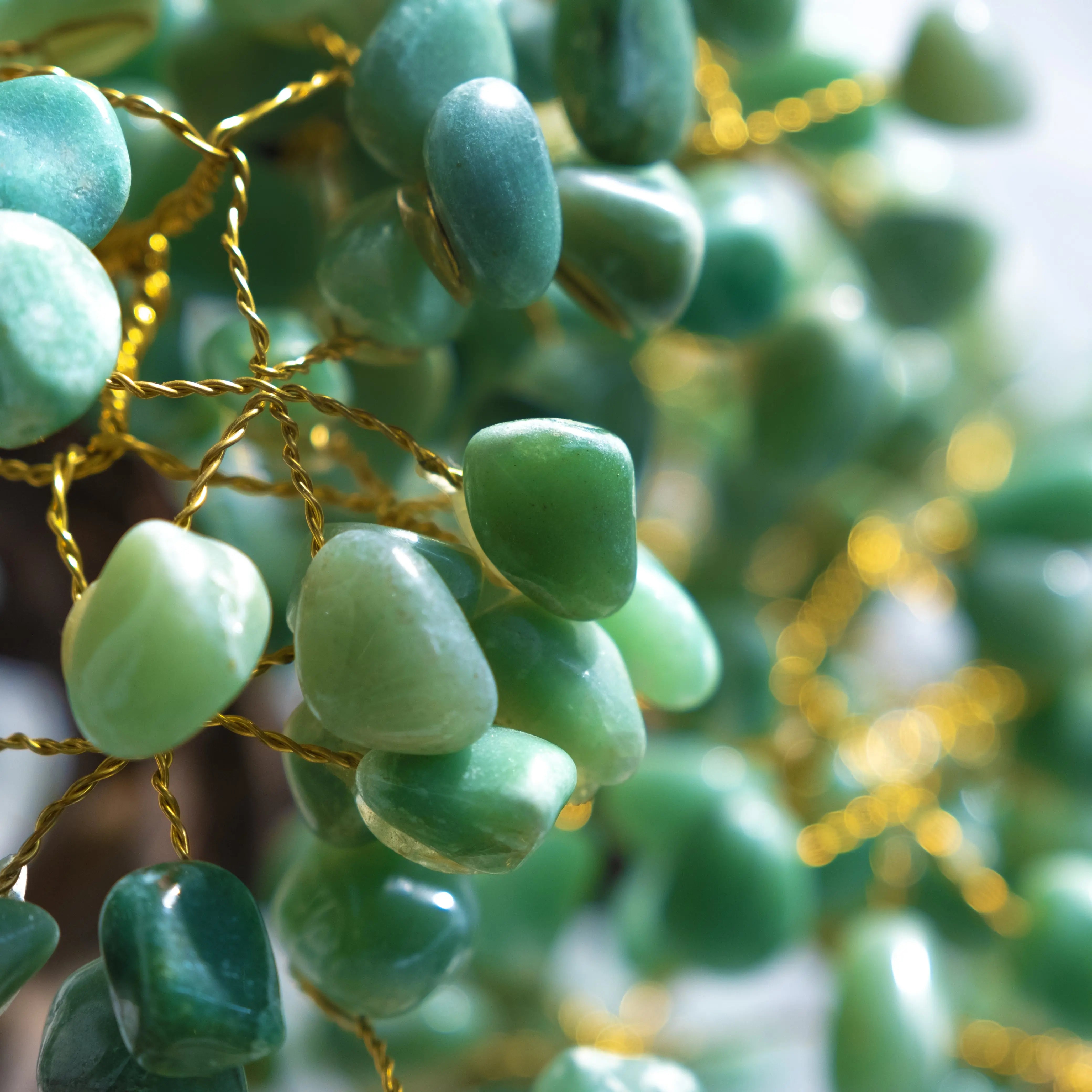 Close-up of handcrafted Aventurine Crystal Bonsai Tree branches showcasing green tumbled stones symbolizing prosperity and harmony.