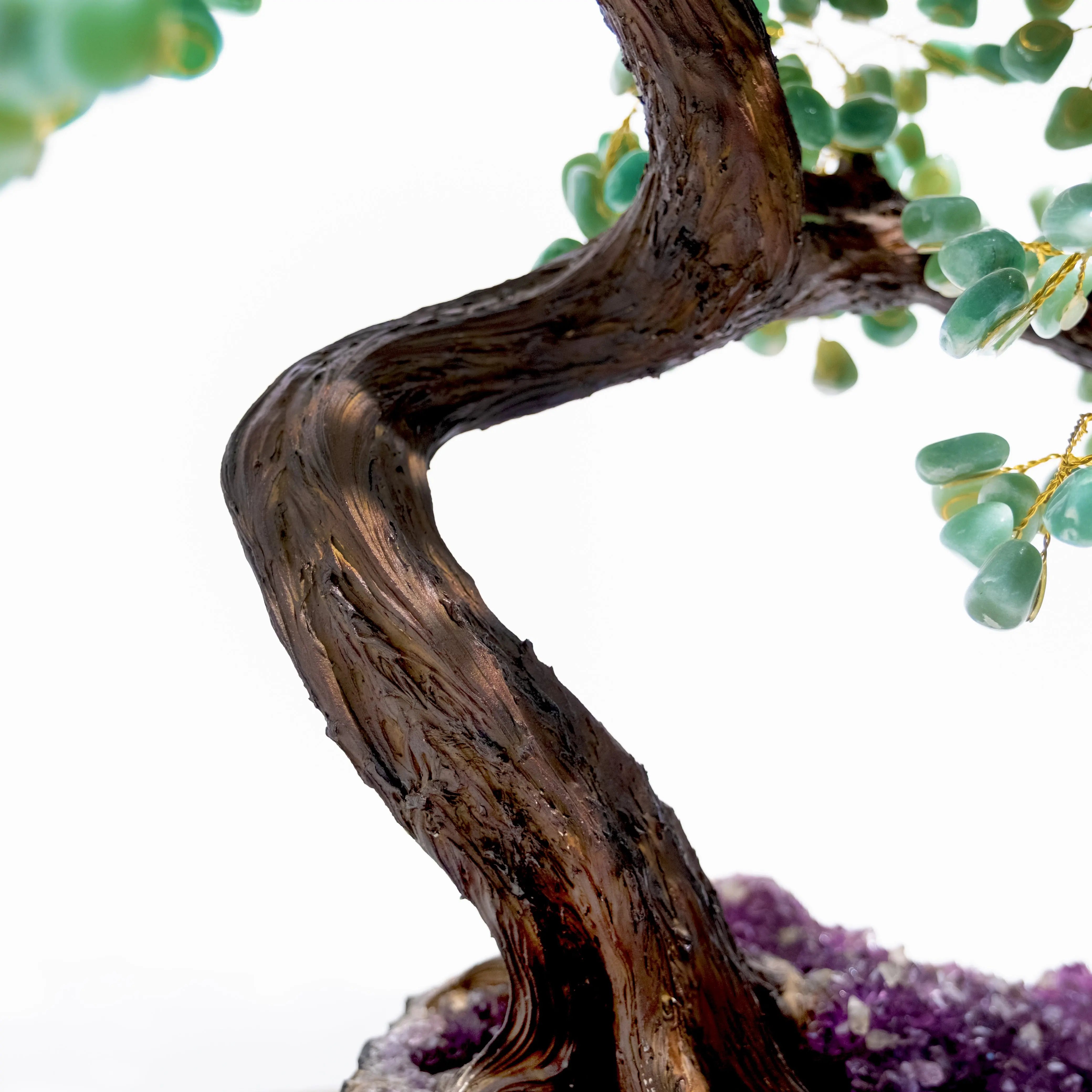 Close-up of a handcrafted Aventurine Crystal Bonsai Tree, emphasizing its twisting trunk and lush green crystal leaves for prosperity.