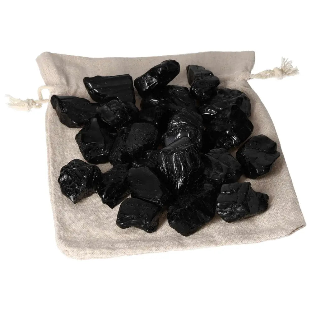 Tumbled Black Tourmaline L crystals in a fabric pouch from Sylvia Crystals, ideal for cleansing negative energy and promoting clarity.
