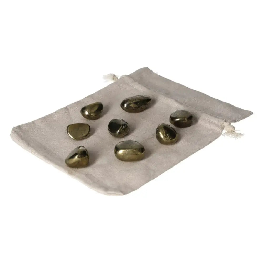 Tumbled Chalcopyrite healing crystals on a cloth bag, ideal for stress relief, boosting self-confidence, and enhancing psychic abilities.