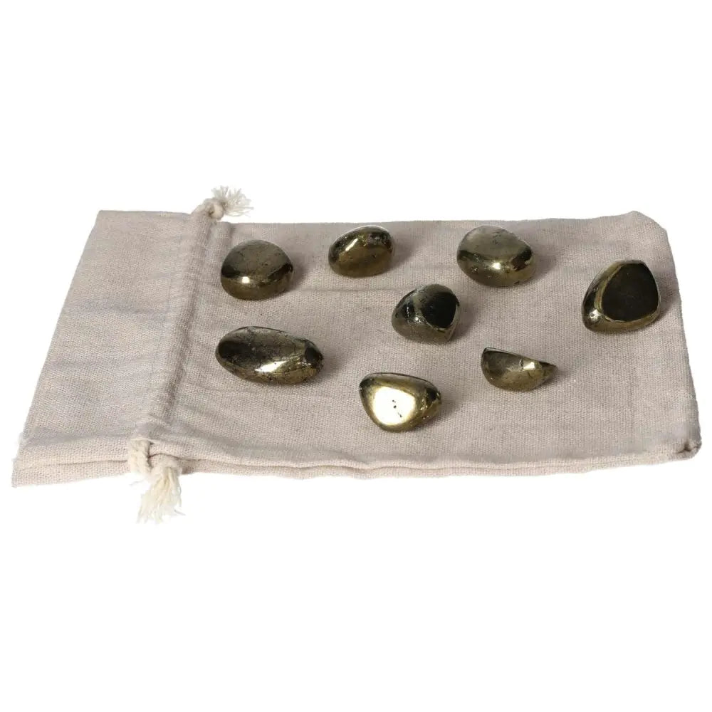 Tumbled Chalcopyrite stones on a drawstring bag, known for boosting self-confidence, relieving stress, and enhancing psychic abilities.