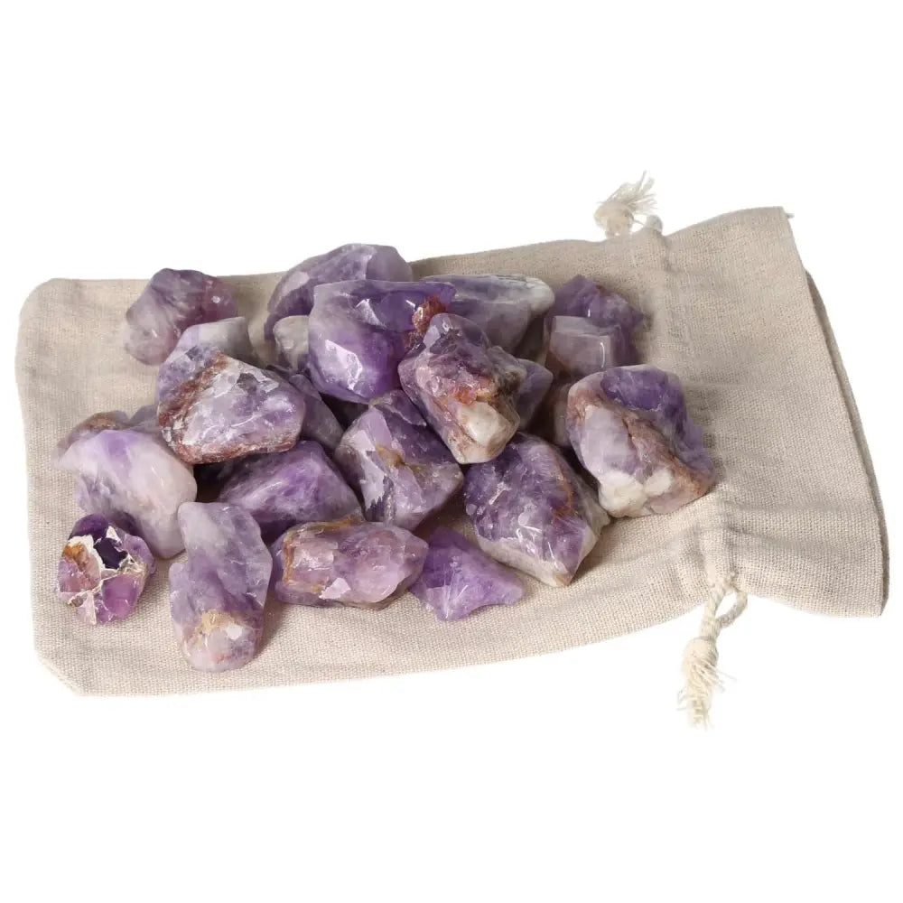 Tumbled Chevron Amethyst stones with deep purple and white bands on a beige sack, from Sylvia Crystals.