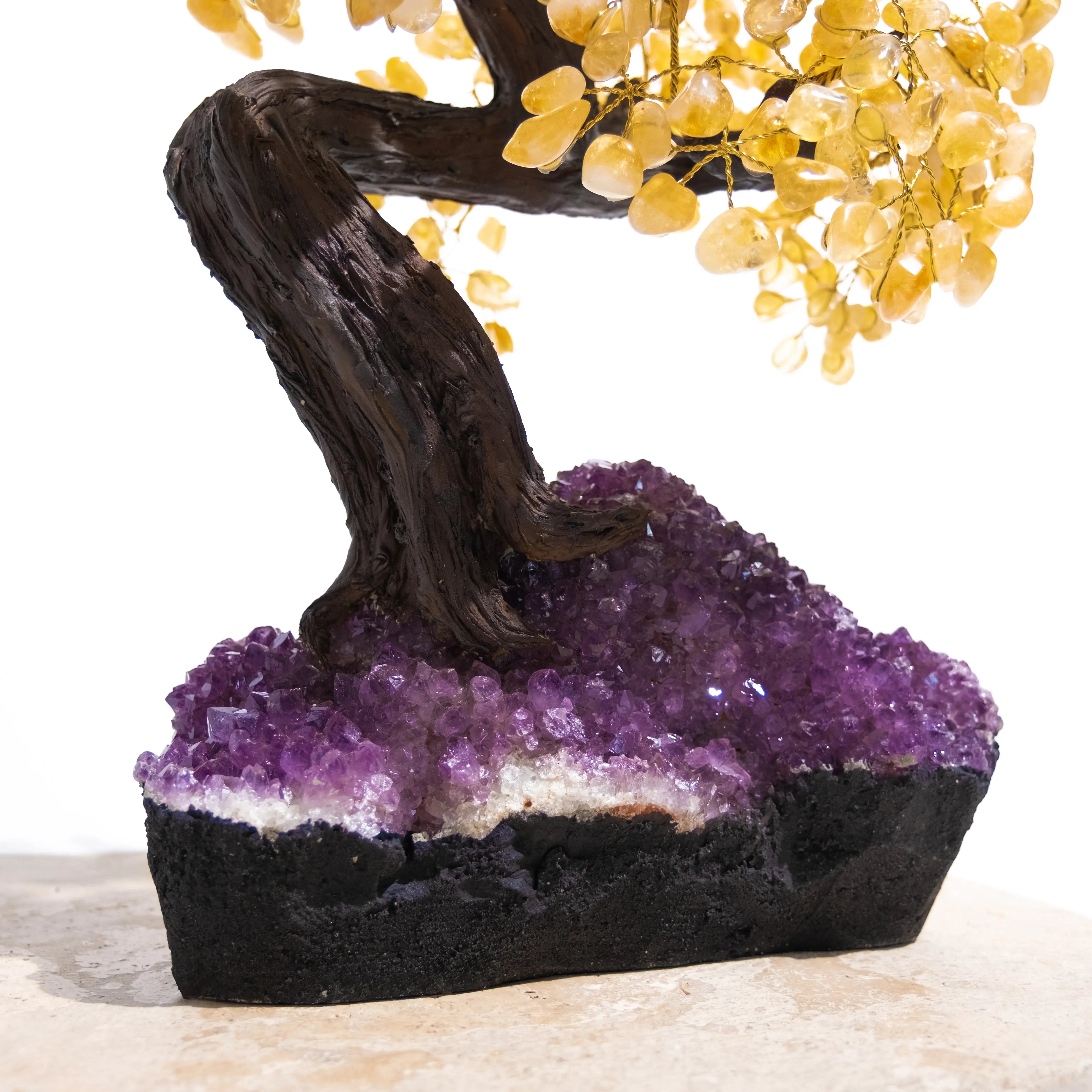 Close-up of a handcrafted Citrine Crystal Bonsai Tree with yellow citrine leaves and a purple amethyst base, promoting prosperity and positivity.