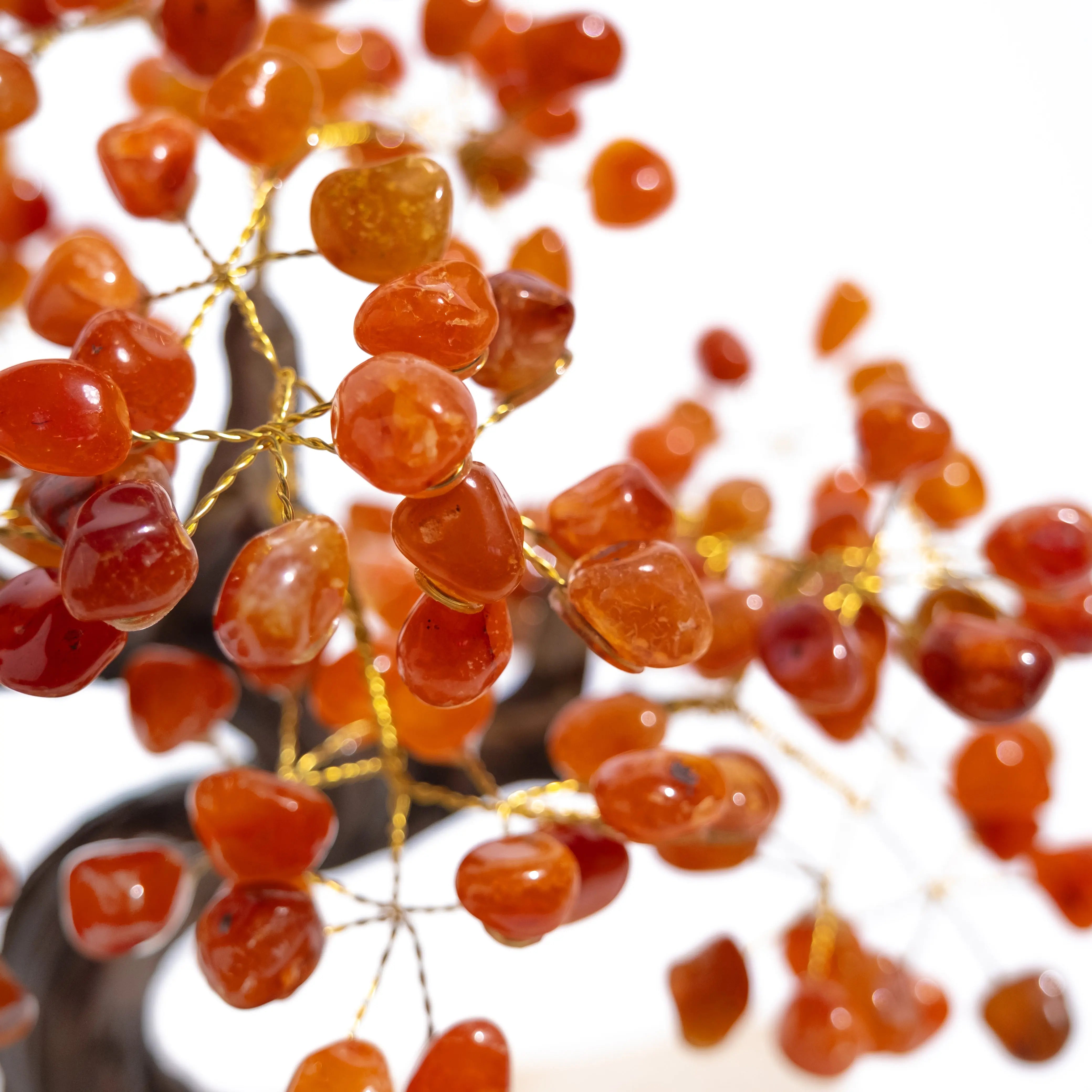 Close-up of a tumbled Carnelian bonsai tree with vibrant gemstones enhancing creativity, motivation, and positive energy.