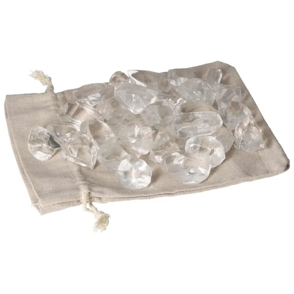 Luxurious tumbled quartz ice cubes on a beige drawstring bag, enhancing spirituality and elegance by Sylvia Crystals.