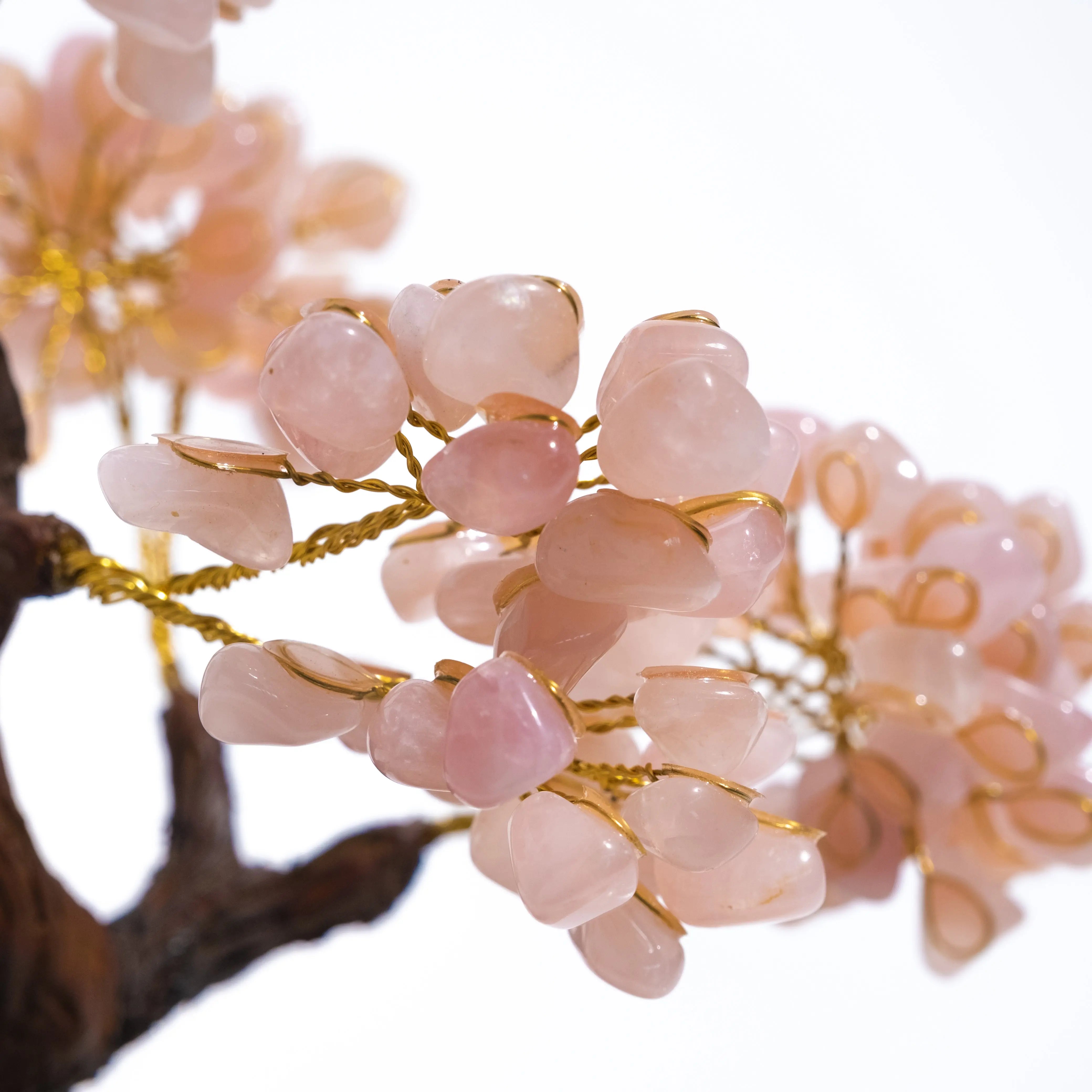 Close-up of a Tumbled Rose Quartz Tree showcasing pink gemstones on gold wire branches, symbolizing love and healing energy.