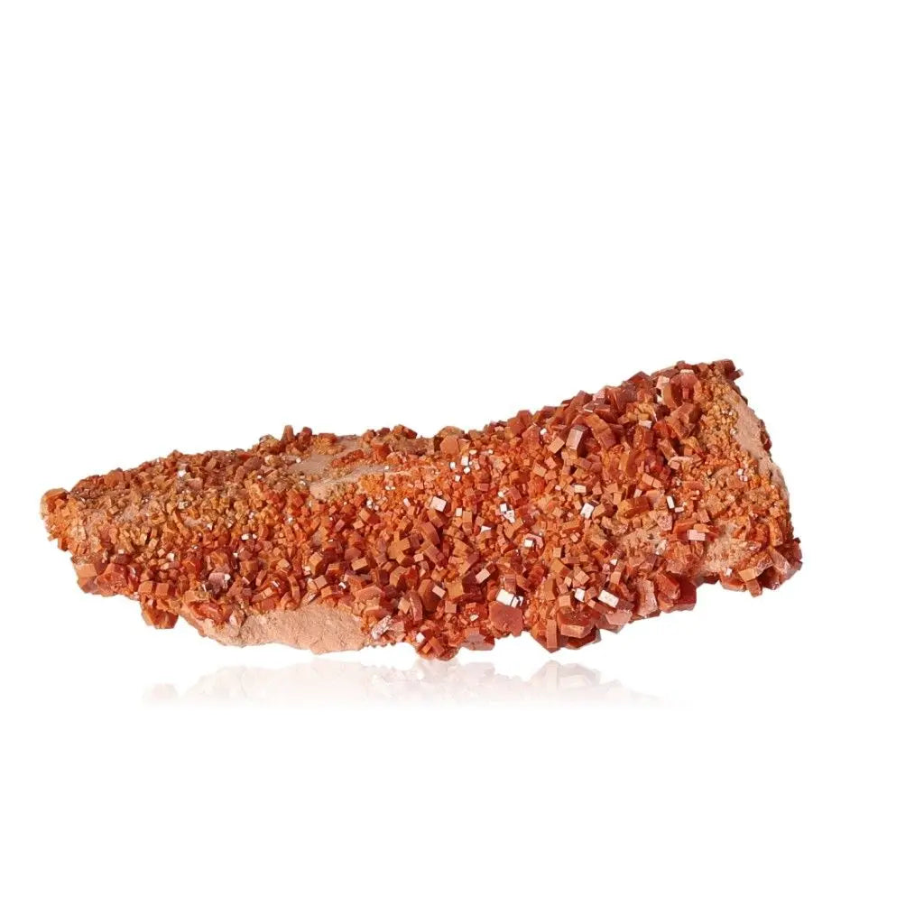 Vanadinite Druze crystal with vibrant red-orange hues, known for enhancing focus and creativity. Ideal for collectors and creatives.