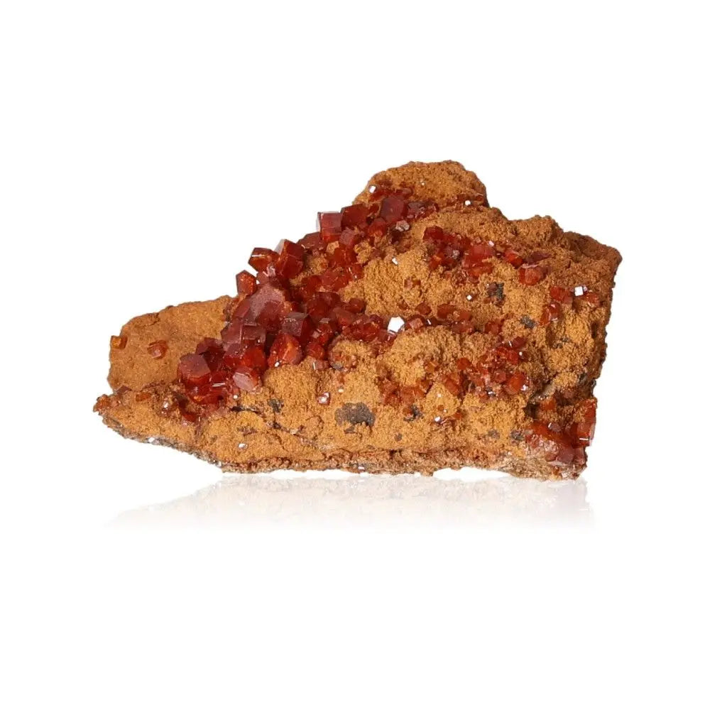 Vanadinite druze with red-orange crystals, known for enhancing focus and creativity.