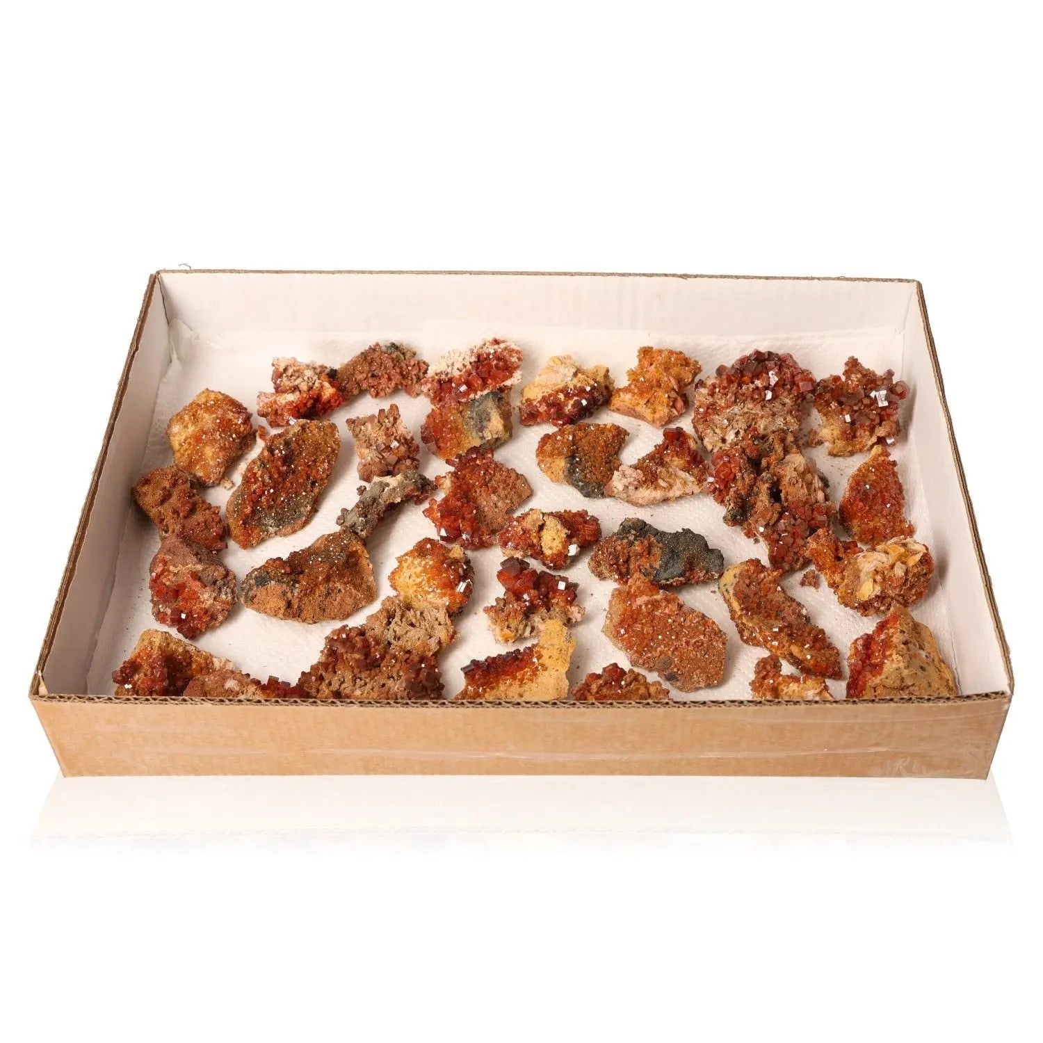 Box of vibrant red-orange vanadinite druzy stones for focus and creativity, ideal for collectors and energy seekers.