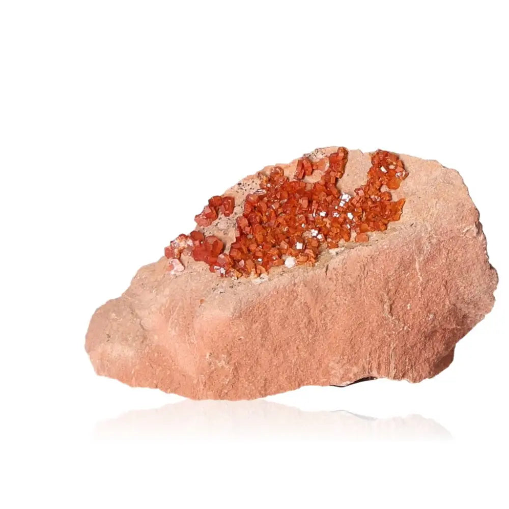 Vibrant red-orange vanadinite druzes on a stone, ideal for collectors and creatives seeking focus and grounding energy.