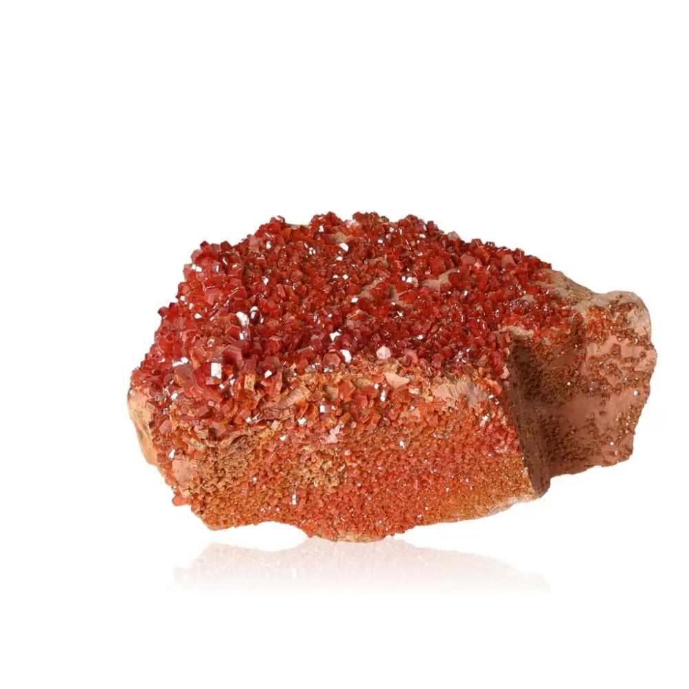 Vibrant red-orange vanadinite druzy crystal formation for creativity and focus.