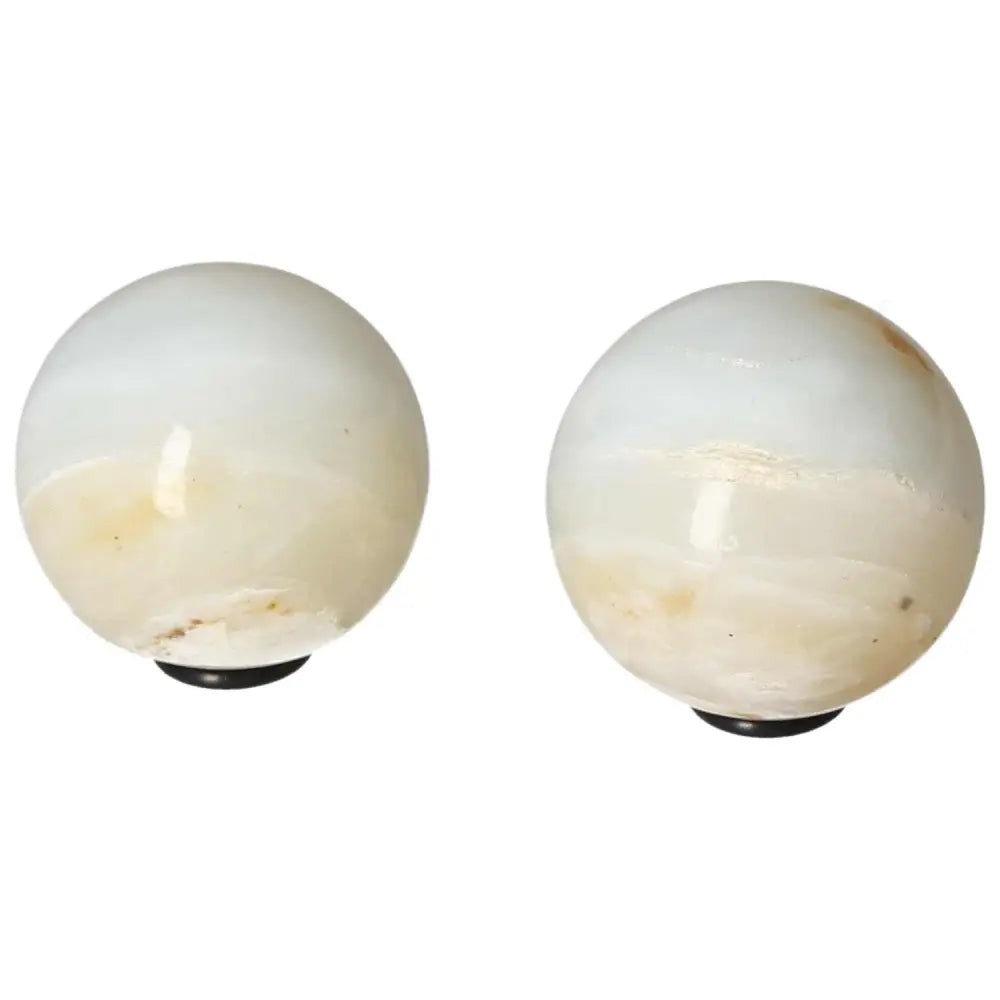 Pair of polished white onyx spheres for strength and self-discipline