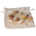 Collection of Yellow Hematoide Thumb Massagers in a White Pouch, ideal for stress relief and energy grounding from Sylvia Crystals.