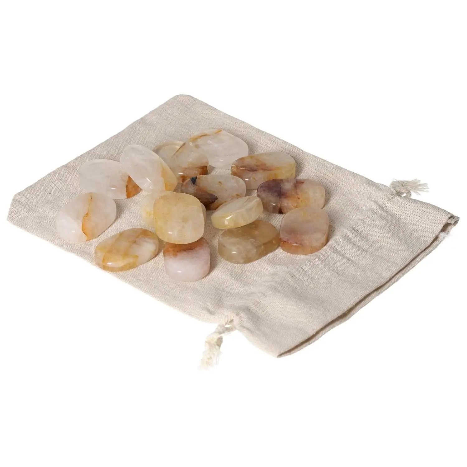 Smooth yellow Hematoide stones on a beige cloth, perfect for stress relief and grounding energy.