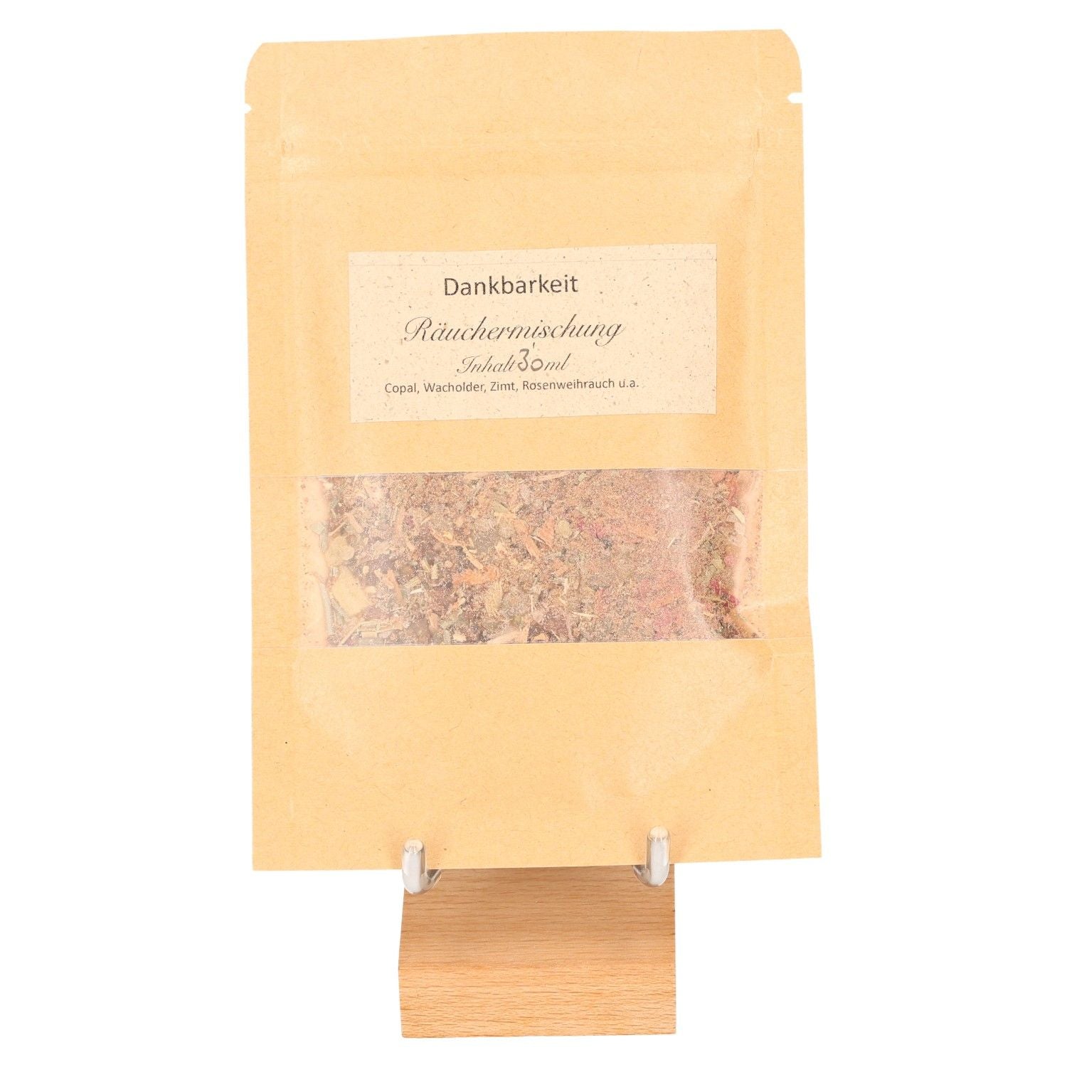 Incense blend Thanksgiving in a brown paper bag for gratitude and reflection practices, displayed on a wooden stand.