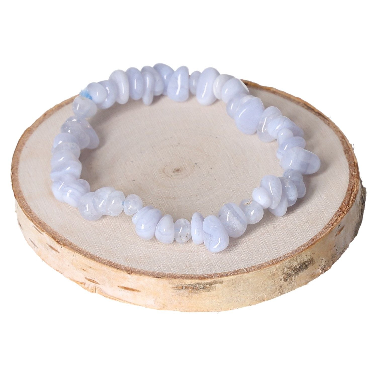 Chalcedony bracelet chips displayed on wooden slice, showcasing natural elegance and gemstone texture.