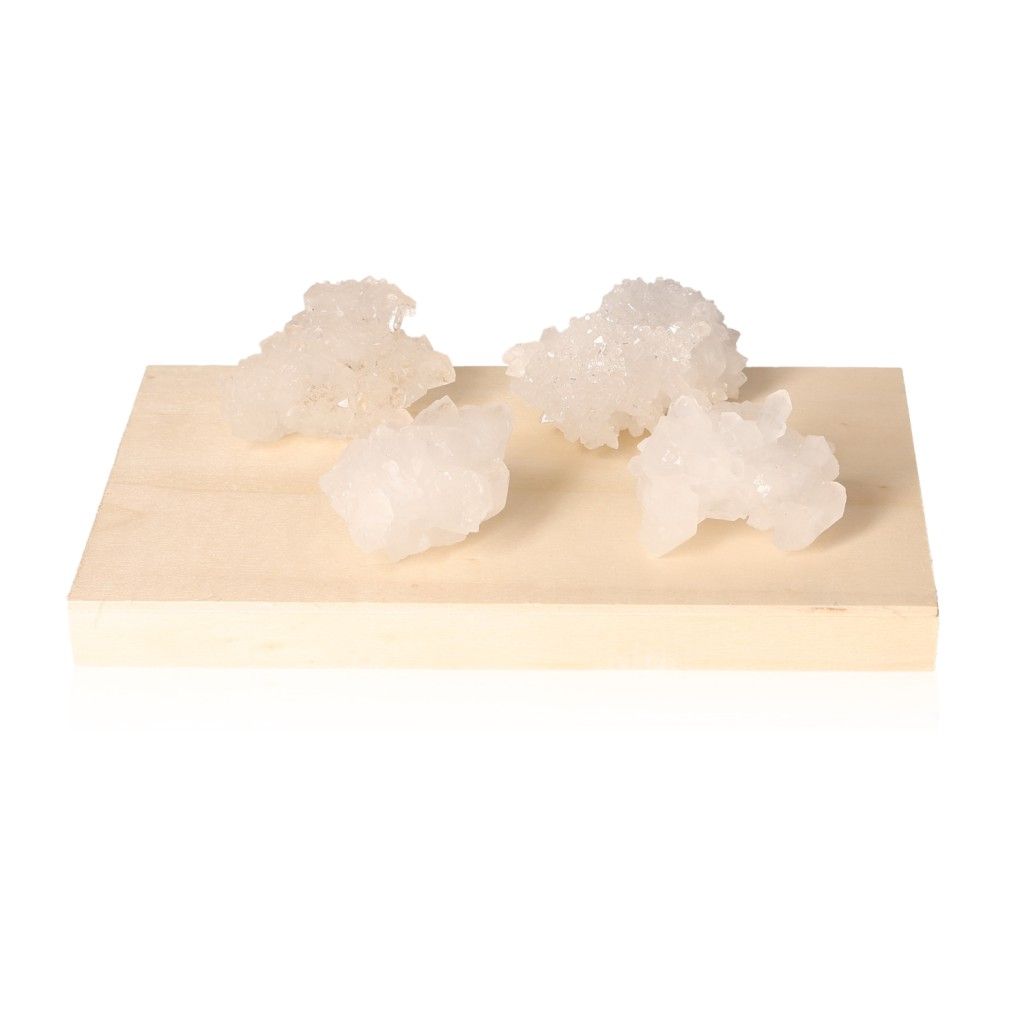 White quartz druzy crystals on wooden block for chakra healing and spiritual enhancement