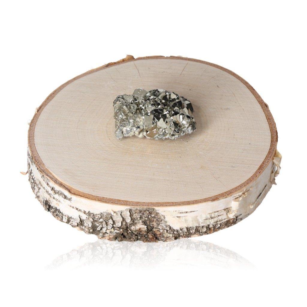 Pyrite druzy on a wooden slice, promoting independence and inspiring new ideas with its shimmering metallic appearance.