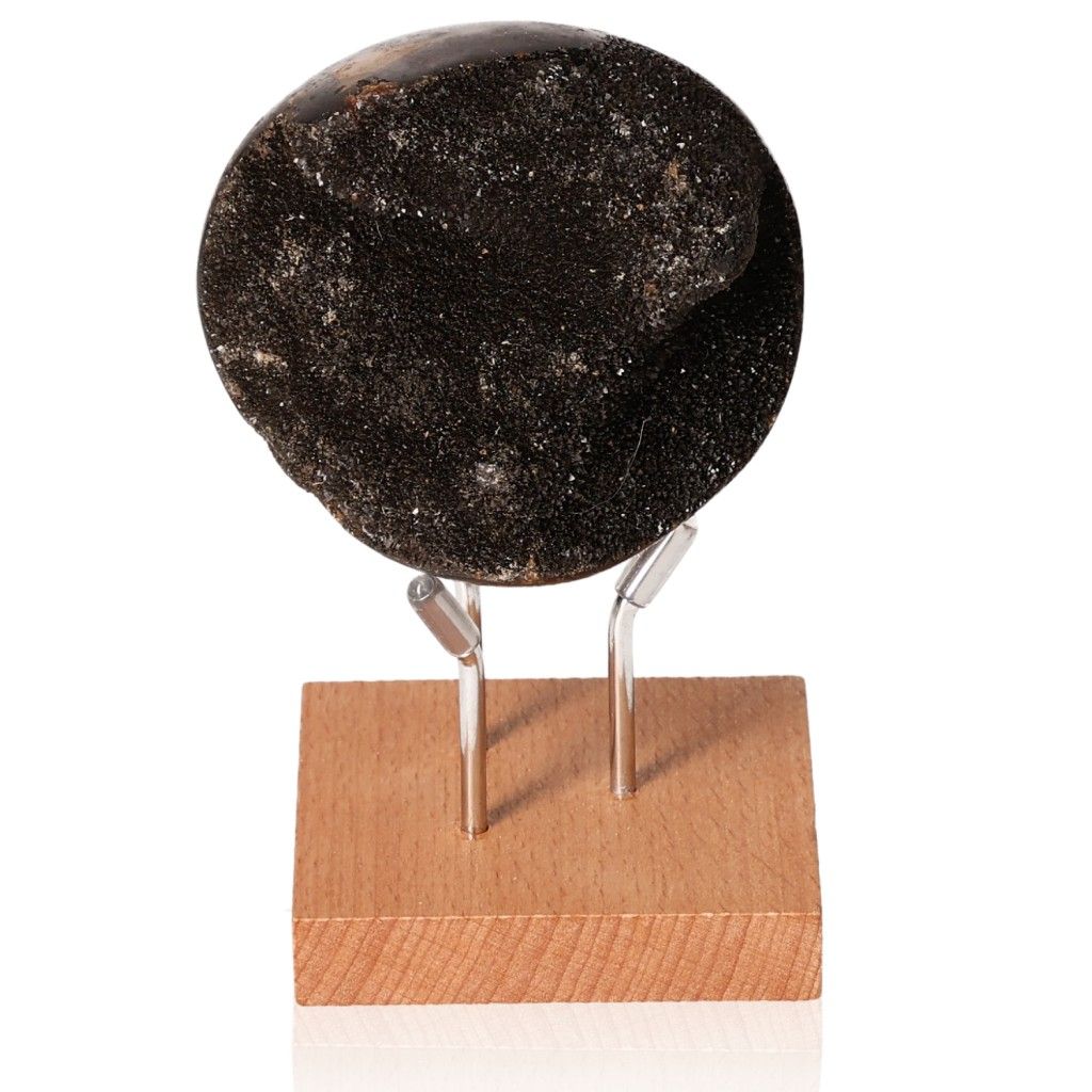 Septarian dragon stone mineral on wooden stand, showcasing unique appearance and symbolic power.