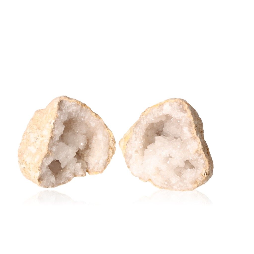 Milky quartz geode cut open to reveal sparkling white crystals, enhancing tranquility and clarity with purifying energy.