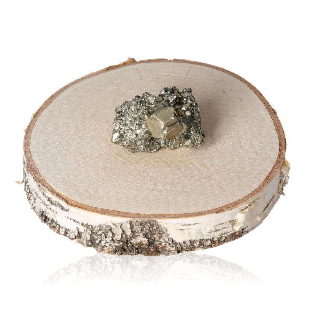 Pyrite druzy stone on a wooden slab, promoting independence and courage, ideal for new ideas and motivation in life.