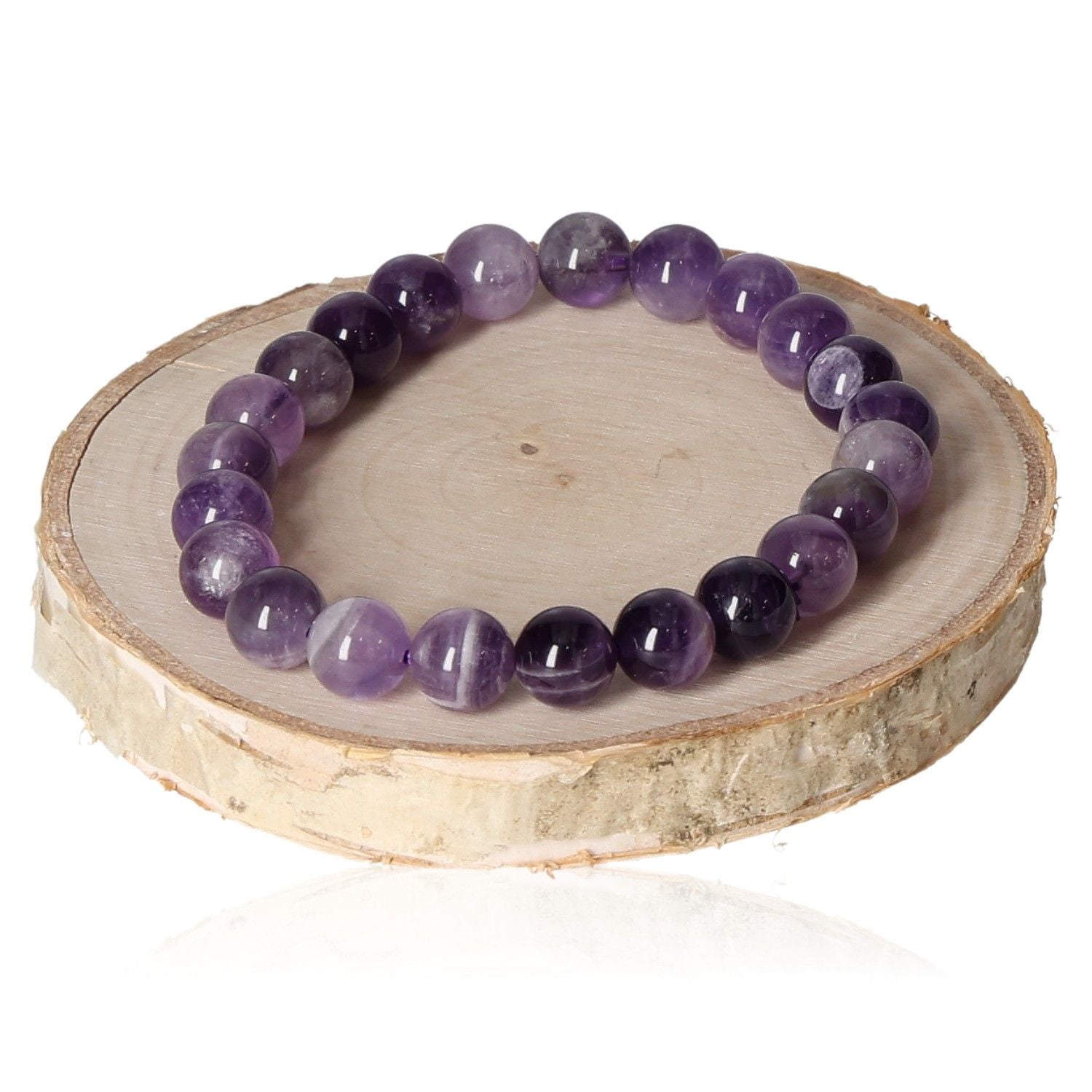 Amethyst bracelet with 8mm beads displayed on a wooden slice, showcasing its rich purple tones and polished finish.