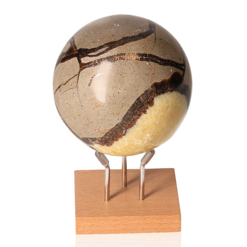 Septarian sphere on wooden stand, showcasing unique patterns and colors, symbolizing power and endurance.