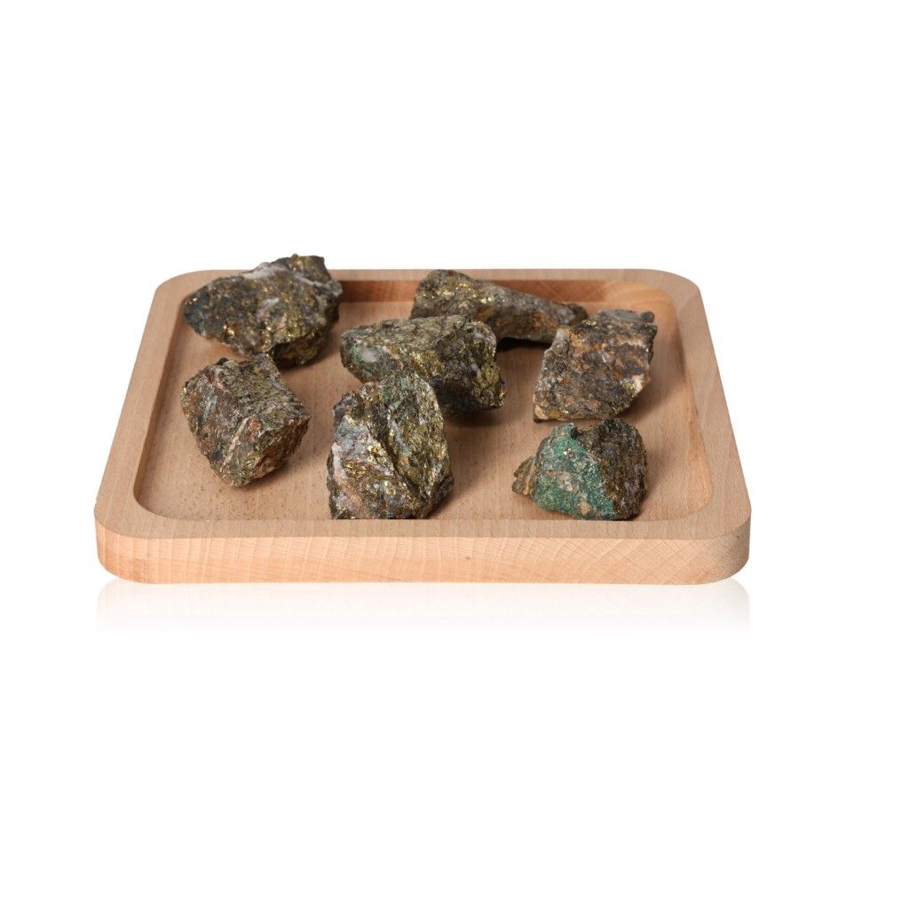 Seven raw mineral stones on a wooden tray showcasing natural textures and earth tones.