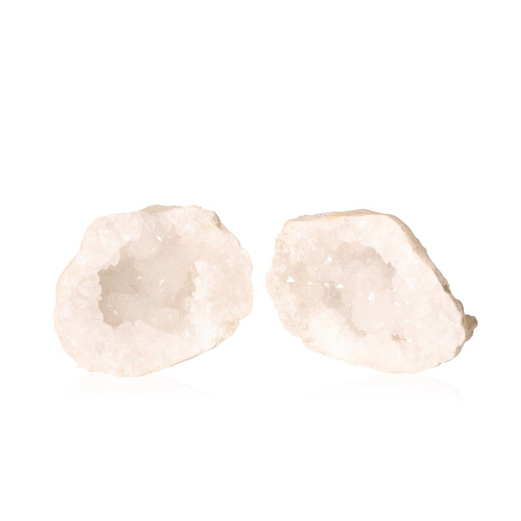 Milky quartz geode split open revealing sparkling cloudy white crystals on a white background.