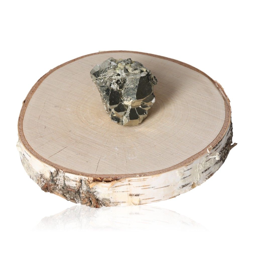 Pyrite druze displayed on a natural wood slice, symbolizing independence and courage in mental and material pursuits.