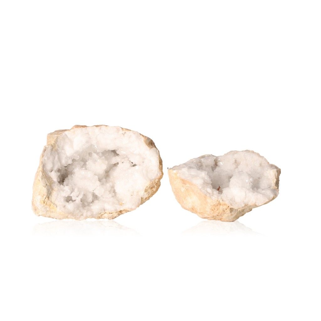 Milky quartz geode halves displaying sparkling white crystals for purification and energy balance.