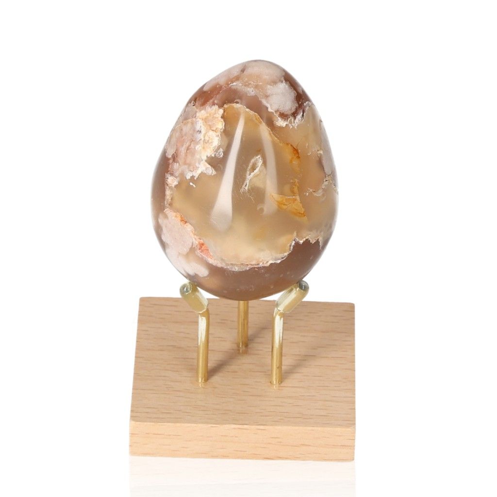 Flower Agate Egg gemstone on a wooden stand showcasing natural patterns and serene beauty.