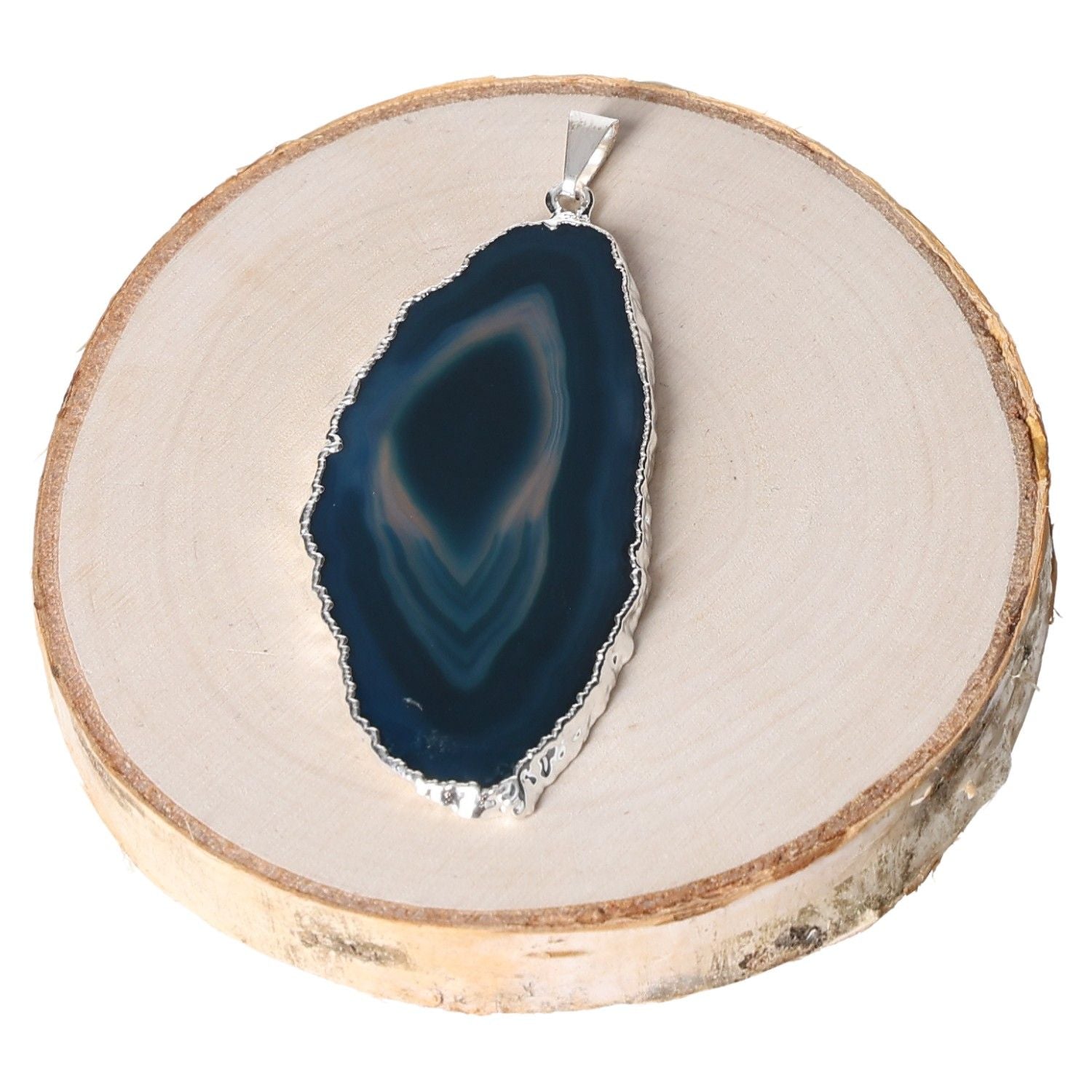 Teal agate slice pendant with metal plating on wooden slab for jewelry display