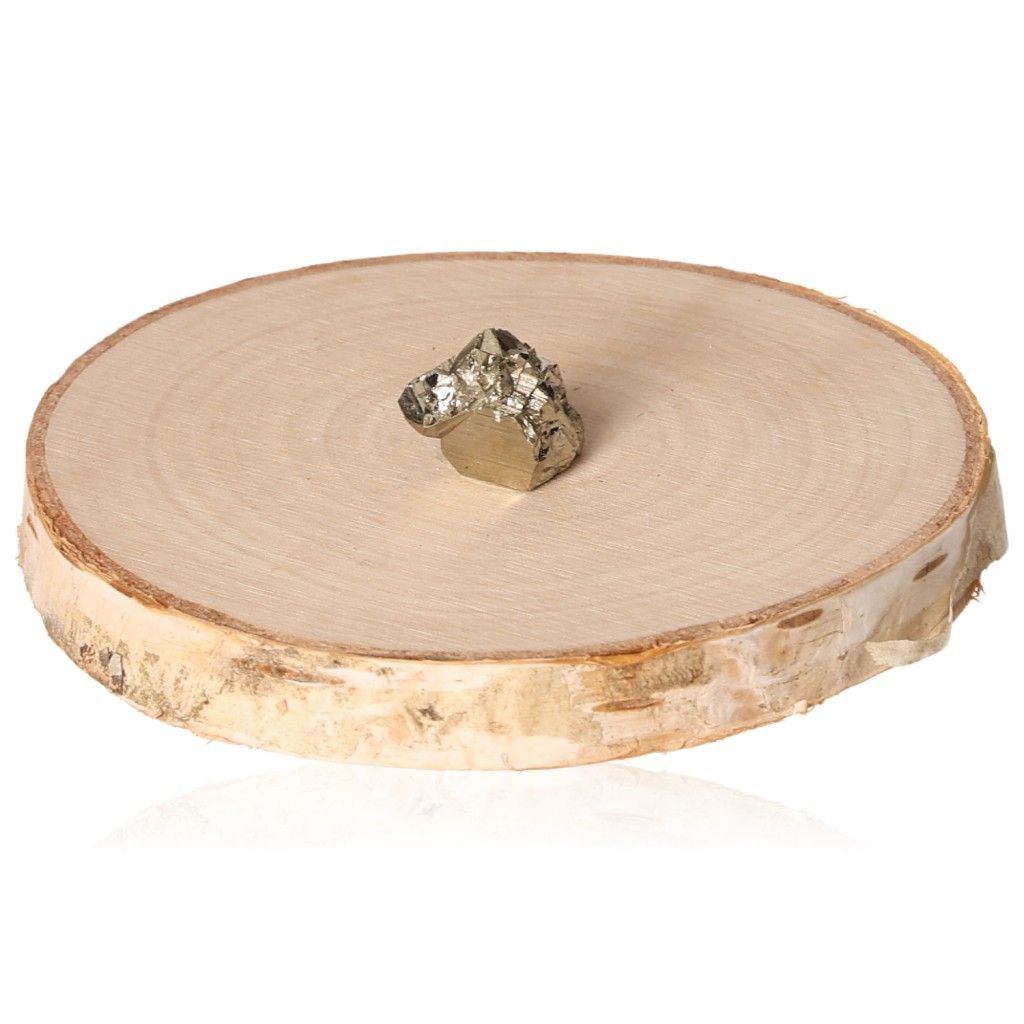 Pyrite druze stone on wooden slice, symbolizing courage and motivation for personal growth and independence.