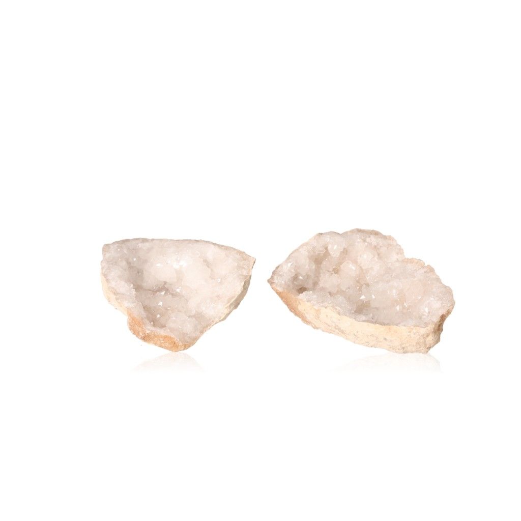 Milky quartz geode halves with sparkling cloudy crystals, known for purifying energy and enhancing tranquility and focus.