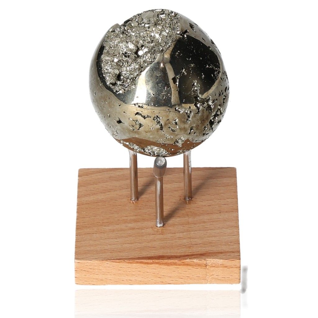 Shiny pyrite sphere on a wooden stand, promoting independence and courage, ideal for inspiring new ideas and achieving goals.