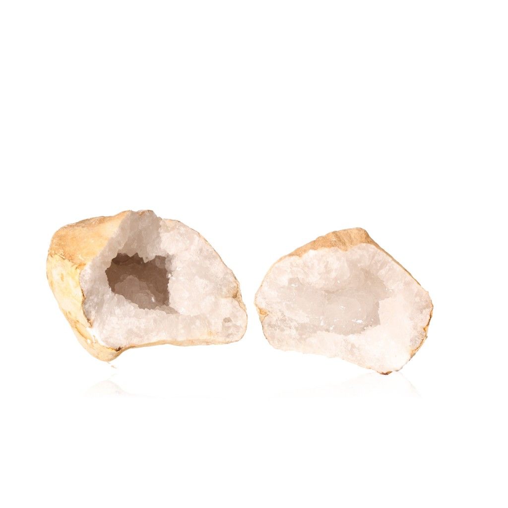 Milky quartz geode split open revealing sparkling white crystals, known for purifying energy and enhancing tranquility and clarity.