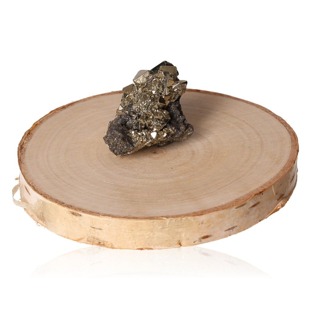 Pyrite druzy crystal on a wooden slab for enhancing confidence and goal achievement.