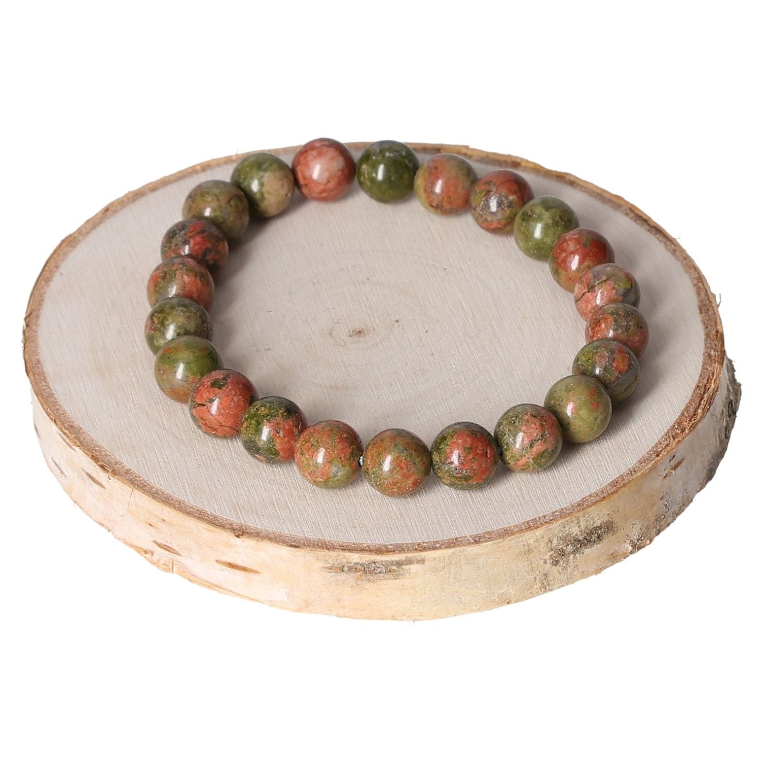 Unakite bracelet with 8mm beads displayed on a wooden slice, showcasing green and pink natural stones, perfect for stylish accessorizing.