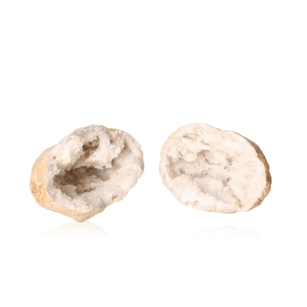 Milky quartz geode halves with sparkling white crystals and rugged outer shells, enhancing energy balance and promoting tranquility.