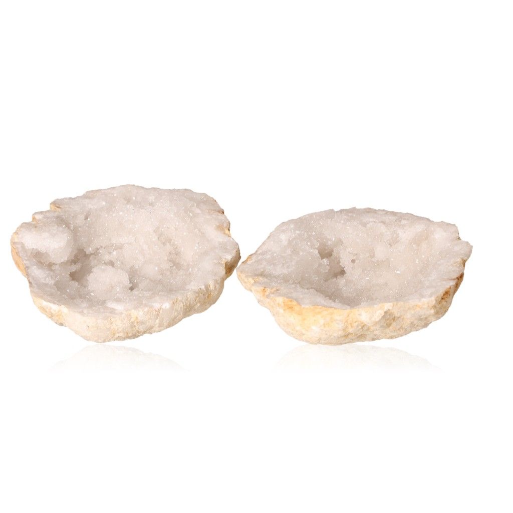 Milky quartz geode halves revealing sparkling white crystals, known for purifying energy and enhancing tranquility and focus.