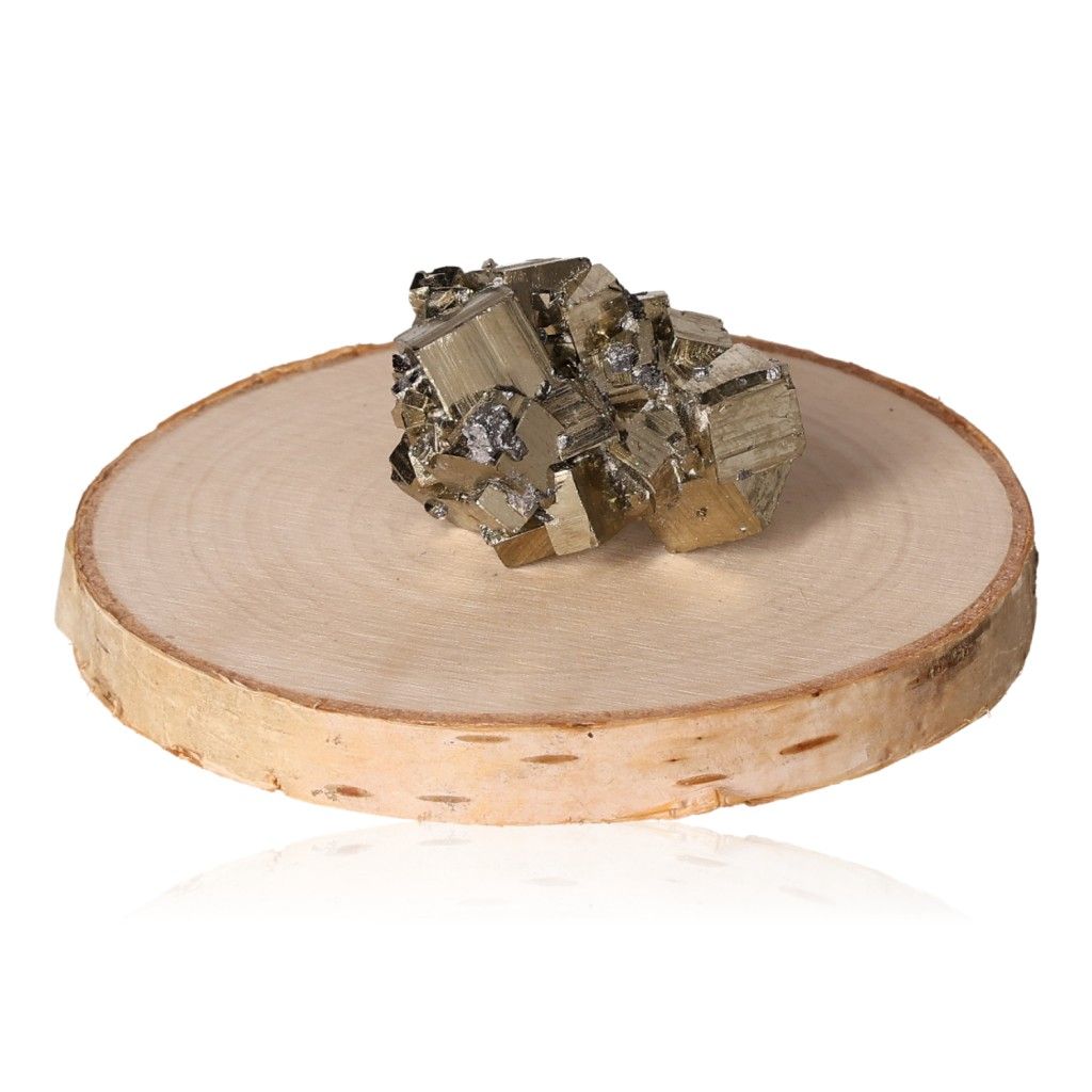 Pyrite druzy stone on a wooden slab, enhancing independence and courage, encouraging new ideas and goal achievement.