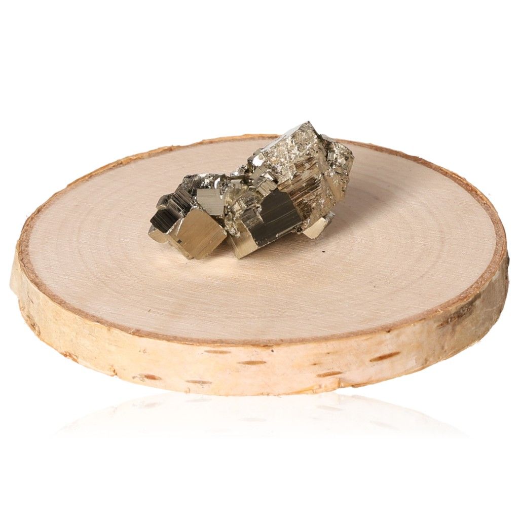 Pyrite druze stone on wooden slab, promoting independence and courage, ideal for motivation and achieving goals.