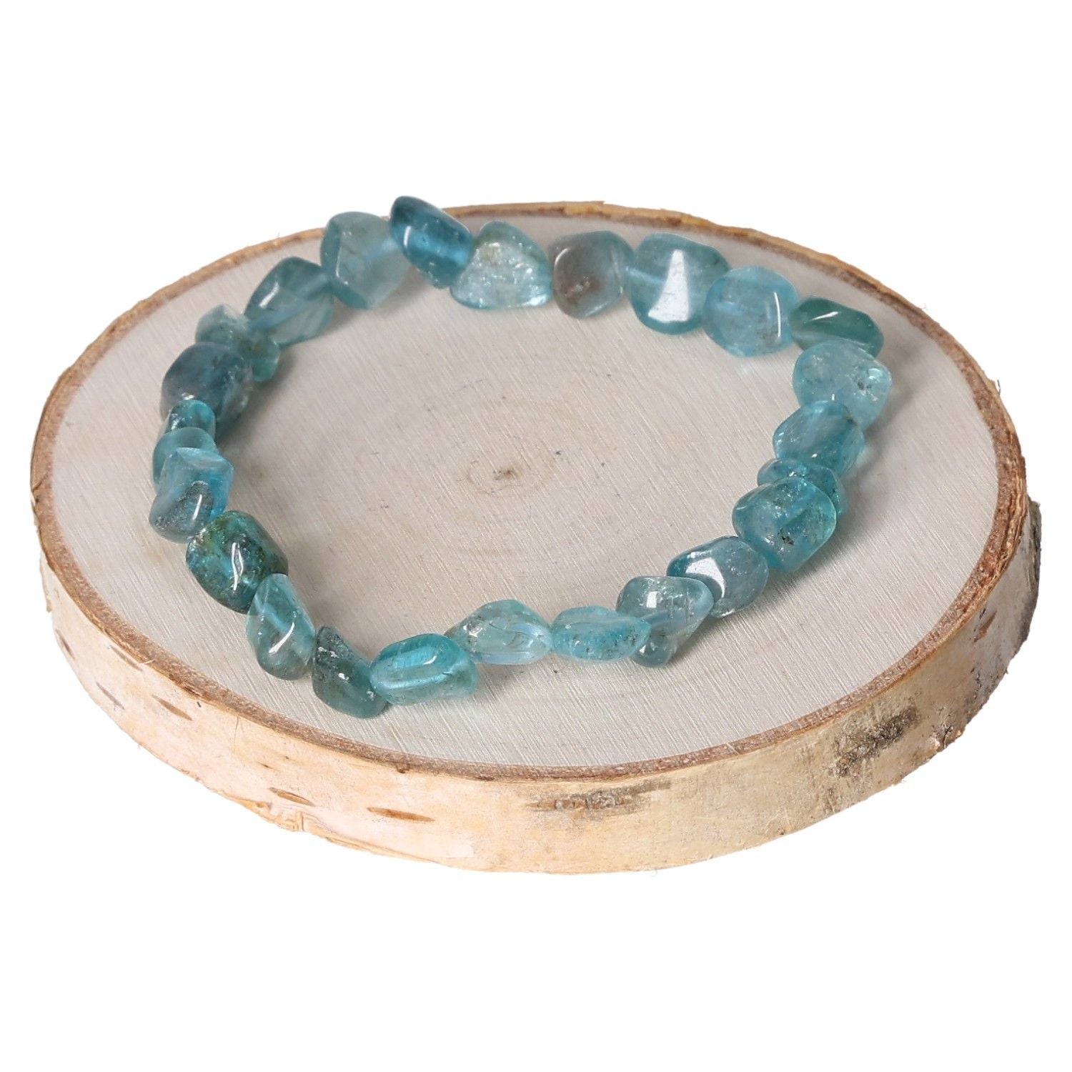 Apatite blue bracelet with tumbled stones on wooden display, showcasing natural gemstone jewelry.